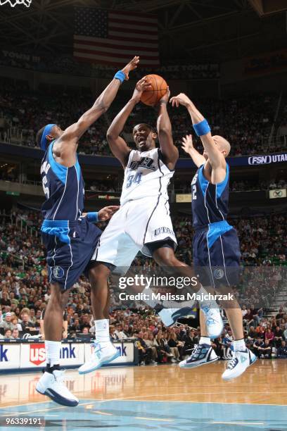 Miles of the Utah Jazz splits the defense of Josh Howard and Jason Kidd # of the Dallas Mavericks and goes up for the shot at EnergySolutions Arena...