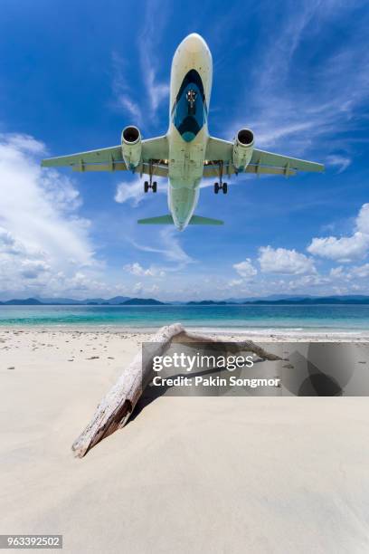 seascape and blue sky with airplane background at mai khao beach - private jet stock-fotos und bilder
