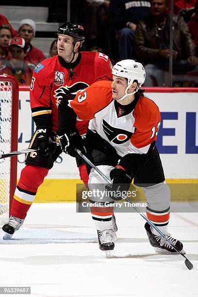 Ian White of the Calgary Flames skates against Daniel Carcillo of the Philadelphia Flyers on February 1, 2010 at Pengrowth Saddledome in Calgary,...