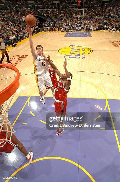 Adam Morrison of the Los Angeles Lakers lays up a shot against Jodie Meeks of the Milwaukee Bucks during the game on January 10, 2010 at Staples...