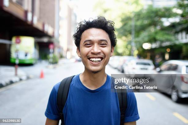 portrait of a young malay man on the street - malaiischer herkunft stock-fotos und bilder