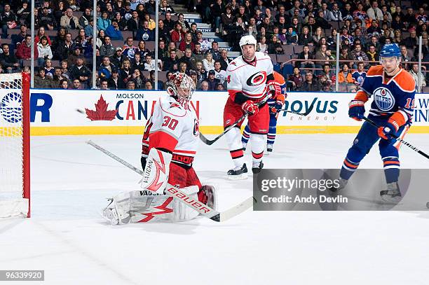 Patrick O'Sullivan of the Edmonton Oilers watches the puck go past Cam Ward of the Carolina Hurricanes for a first period goal at Rexall Place on...