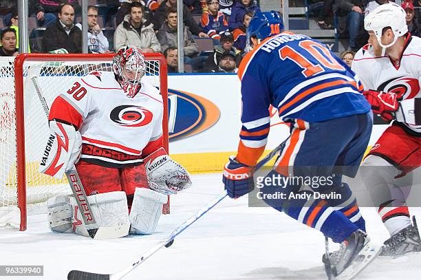 Cam Ward of the Carolina Hurricanes makes a save off a shot from Shawn Horcoff of the Edmonton Oilers at Rexall Place on February 1, 2010 in...