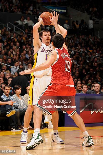 Adam Morrison of the Los Angeles Lakers moves the ball against Carlos Delfino of the Milwaukee Bucks during the game on January 10, 2010 at Staples...