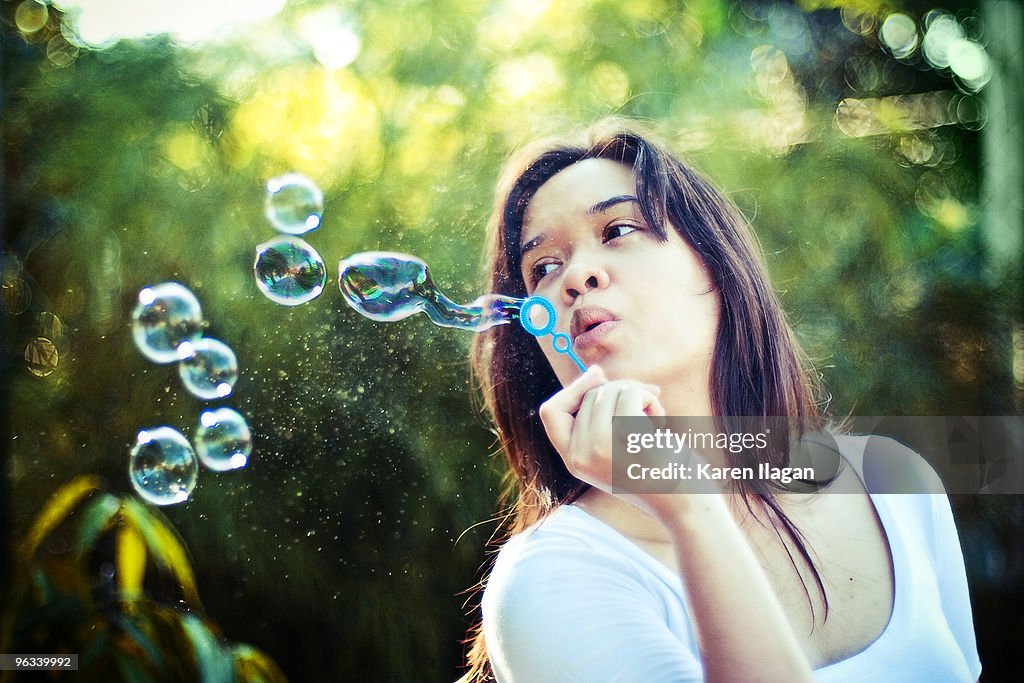Woman blowing bubbles