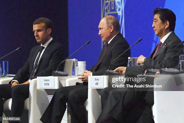 French President Emmanuel Macron, Russian President Vladimir Putin and Japanese Prime Minister Shinzo Abe attend the St. Petersburg International...