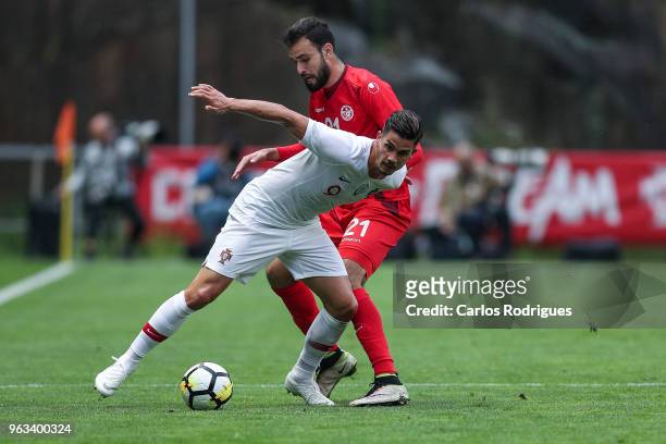 Portugal and AC Milan forward Andre Silva vies with Tunisia defender Hamdi Naguez for the ball possession during the Portugal vs Tunisia...