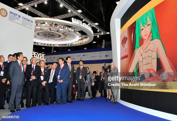 Japanese Prime Minister Shinzo Abe inspects a pavillion during the St. Petersburg International Economic Forum on May 25, 2018 in Saint Petersburg,...