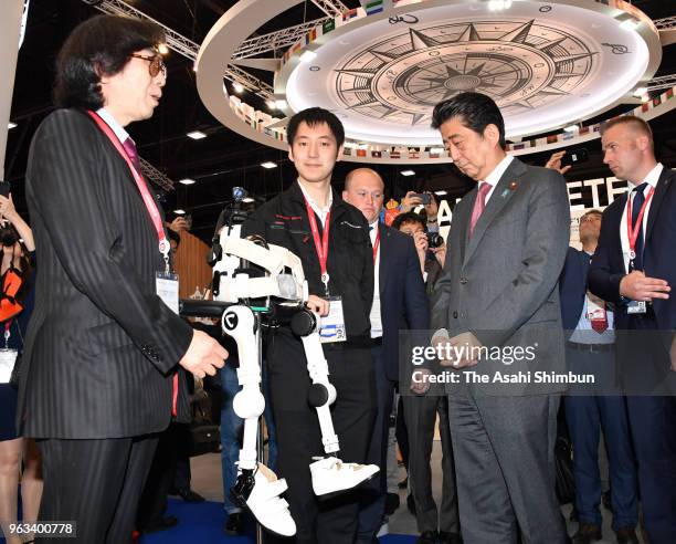 Japanese Prime Minister Shinzo Abe inspects a pavillion during the St. Petersburg International Economic Forum on May 25, 2018 in Saint Petersburg,...