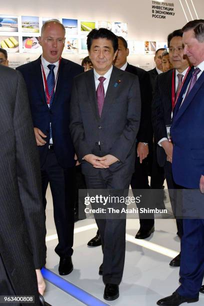 Japanese Prime Minister Shinzo Abe inspects a pavillion during the St. Petersburg International Economic Forum on May 25, 2018 in Saint Petersburg,...