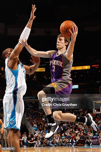 Goran Dragic of the Phoenix Suns shoots the ball over David West of the New Orleans Hornets at the New Orleans Arena on February 1, 2010 in New...