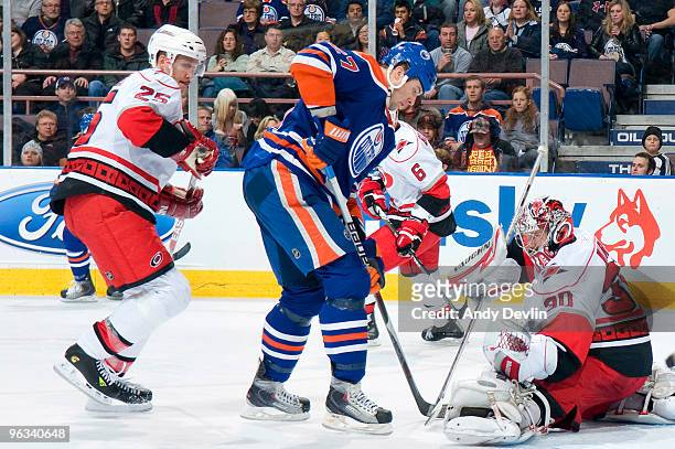 Cam Ward of the Carolina Hurricanes makes the save in close on Dustin Penner of the Edmonton Oilers at Rexall Place on February 1, 2010 in Edmonton,...