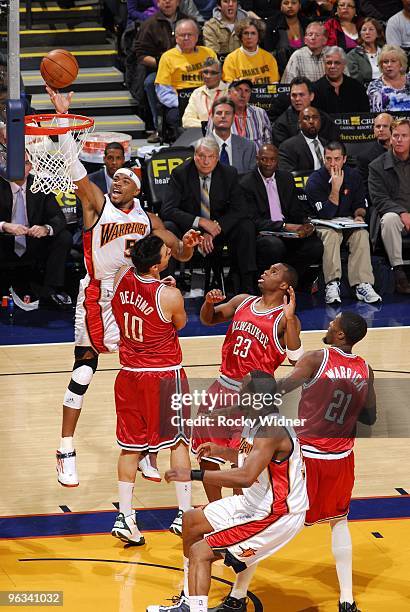 Corey Maggette of the Golden State Warriors shoots a layup Carlos Delfino, Jodie Meeks and Hakim Warrick of the Milwaukee Bucks during the game at...