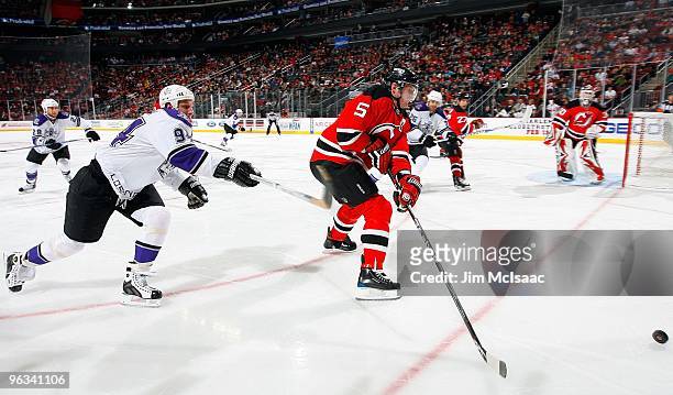 Colin White of the New Jersey Devils skates against Ryan Smyth of the Los Angeles Kings at the Prudential Center on January 31, 2010 in Newark, New...