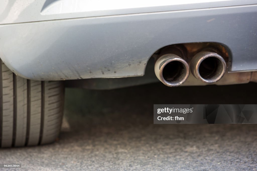 Dirty exhaust pipe of a car (Berlin, Germany)