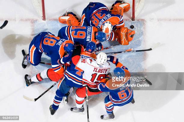 Jeff Deslauriers of the Edmonton Oilers frantically looks for the puck in a scrum in front of the net against the Carolina Hurricanes at Rexall Place...