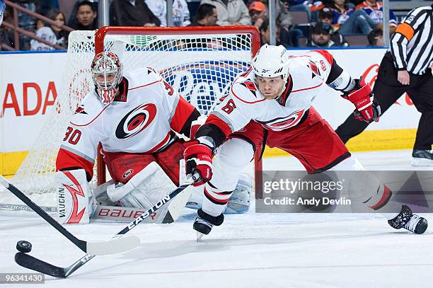 Cam Ward and Tim Gleason of the Carolina Hurricanes defend the zone against the Edmonton Oilers at Rexall Place on February 1, 2010 in Edmonton,...