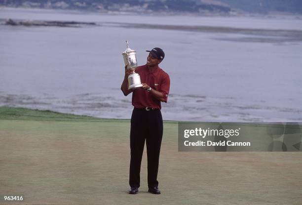 Tiger Woods of the USA poses with the winning trophy after winning the 100th US Open held at the Pebble Beach Golf Links, in Pebble Beach,...