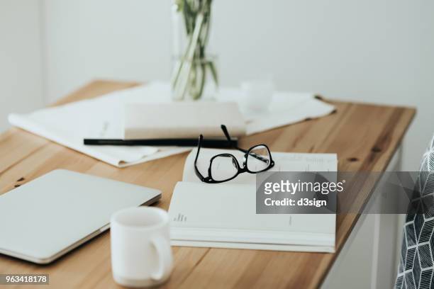 workspace table with smartphone, eyeglasses, schedule calendar and coffee - still life foto e immagini stock
