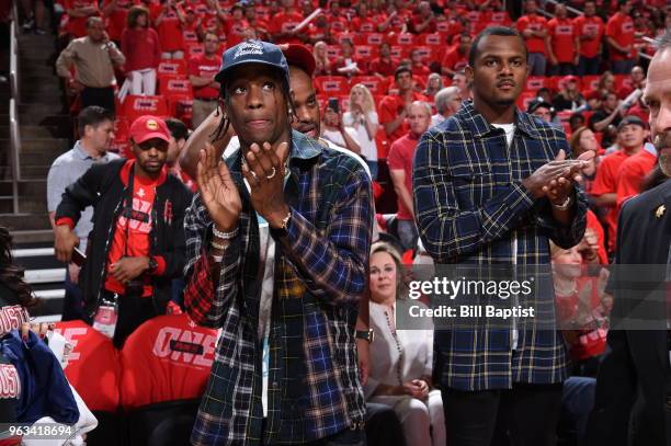 Travis Scott and Deshaun Watson look on in Game Seven of the Western Conference Finals during the 2018 NBA Playoffs between the Golden State Warriors...