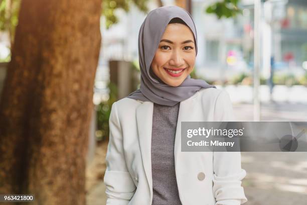 attractive smiling young malaysian woman in kuala lumpur - female likeness stock pictures, royalty-free photos & images