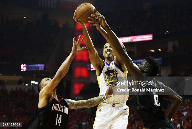 Shaun Livingston of the Golden State Warriors rebounds against Gerald Green and Clint Capela of the Houston Rockets in the first half of Game Seven...