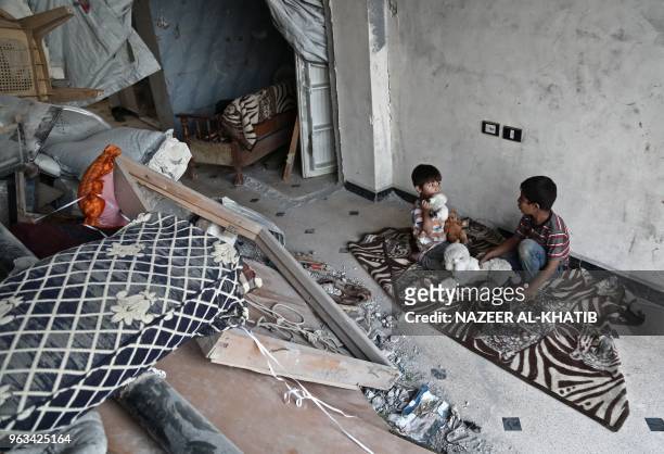 Syrian children Saad and Mohamad, sons of Mehdi Haymur play in Afrin, on May 26, 2018. Displaced from their homes in Syria's Eastern Ghouta, families...
