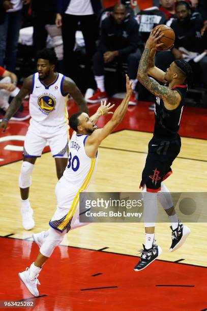 Gerald Green of the Houston Rockets shoots against Stephen Curry of the Golden State Warriors in the first half of Game Seven of the Western...