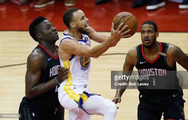 Stephen Curry of the Golden State Warriors goes up against Clint Capela and Trevor Ariza of the Houston Rockets in the second quarter of Game Seven...
