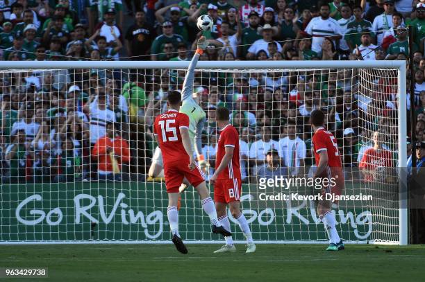 Goalkeeper Wayne Hennessey of Wales makes a save on shot on goal by Hector Herrera of Mexico during the first half of their friendly international...