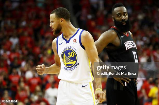 Stephen Curry of the Golden State Warriors reacts as James Harden of the Houston Rockets looks on in the third quarter of Game Seven of the Western...