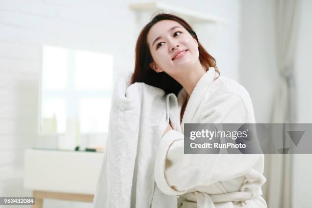 young woman drying hair with towel - blow drying hair stock pictures, royalty-free photos & images