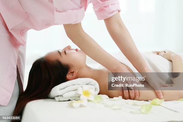 woman receiving arms massage - japanese ethnicity the human body stock pictures, royalty-free photos & images