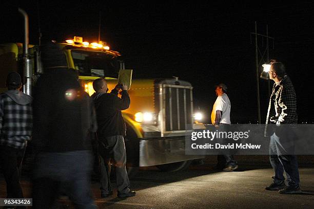 Union workers slow a truck entering the front gate of the Rio Tinto Borax mine on the day after mine owners locked out about 540 employees and called...