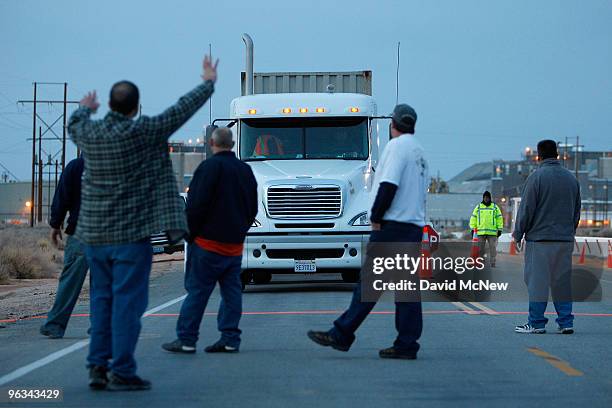 Union workers slow a truck with a load of borax leaving the front gate of the Rio Tinto Borax mine on the day after mine owners locked out about 540...
