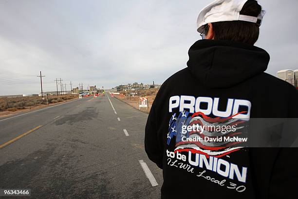 Union workers stand in the road at the front gate of the Rio Tinto Borax mine on the day after mine owners locked out about 540 employees and called...