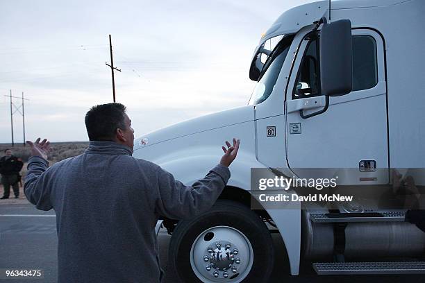 Union worker gestures at the driver of a truck leaving the front gate of the Rio Tinto Borax mine on the day after mine owners locked out about 540...
