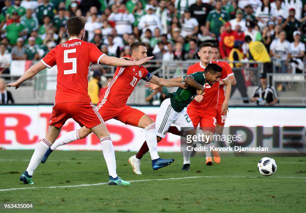 Javier Aquino of Mexico is pushed by Aaron Ramsey of Wales as he attacks the goal during the second half of their friendly international soccer match...