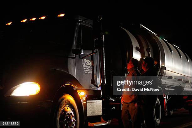 Union workers slow a truck leaving the front gate of the Rio Tinto Borax mine on the day after mine owners locked out about 540 employees and called...
