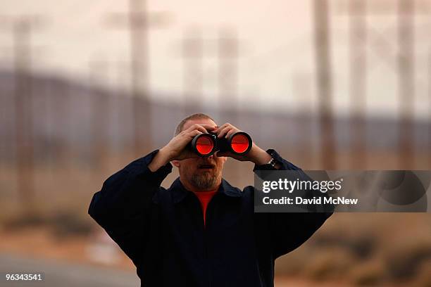 Union worker looks at the Rio Tinto Borax mine through binoculars on the day after mine owners locked out about 540 employees and called in...