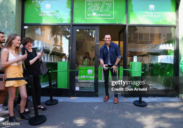 Shannon Noll cuts the ribbon at the launch of Menulog's 25/7 pop up store on May 29, 2018 in Sydney, Australia.