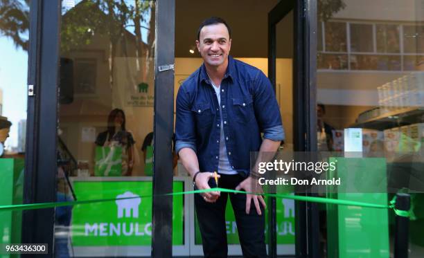 Shannon Noll cuts the ribbon at the launch of Menulog's 25/7 pop up store on May 29, 2018 in Sydney, Australia.
