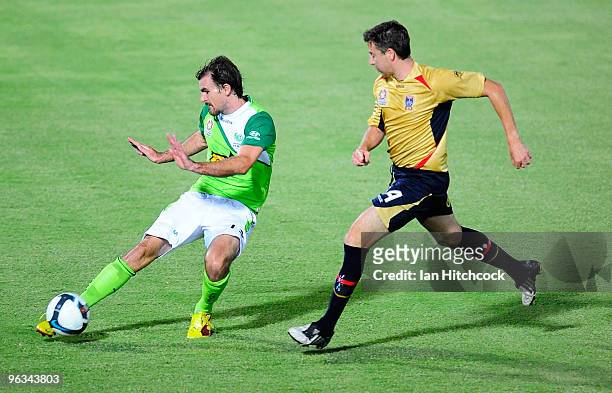 Beau Busch of the Fury clears the bal away from Michael Bridges of the Jets during the round 25 A-League match between North Queensland Fury and the...