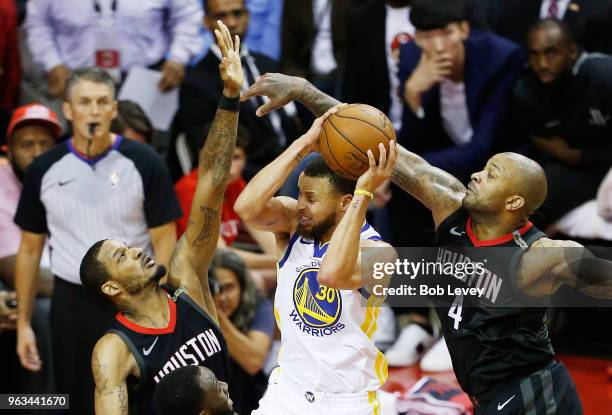 Stephen Curry of the Golden State Warriors goes up against Trevor Ariza and PJ Tucker of the Houston Rockets in the fourth quarter of Game Seven of...