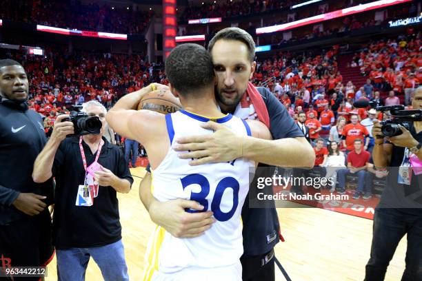 Stephen Curry of the Golden State Warriors hugs Ryan Anderson of the Houston Rockets after Game Seven of the Western Conference Finals during the...