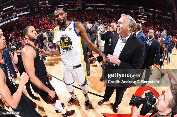 Kevin Durant of the Golden State Warriors and Head Coach Mike D'Antoni of the Houston Rockets talk after the game during Game Seven of the Western...