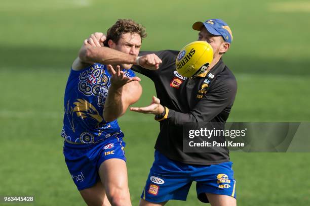 Mark Hutchings works on a drill with Adrian Hickmott during a West Coast Eagles AFL training session at Subiaco Oval on May 29, 2018 in Perth,...