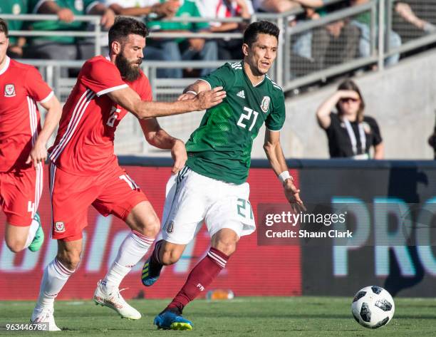 Jesus Molina of Mexico battles Joe Ledley of Wales during the international friendly match between Mexico and Wales at the Rose Bowl on May 28, 2018...