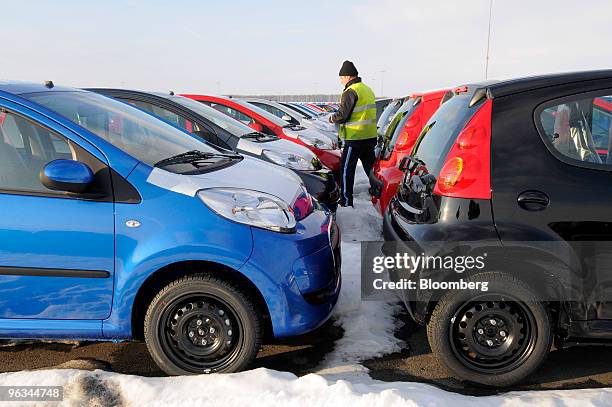 Citroen C1, left, and Peugeot 107 automobiles await export from the Gefco lot next to the Toyota Peugeot Citroen Automobile factory in the industrial...