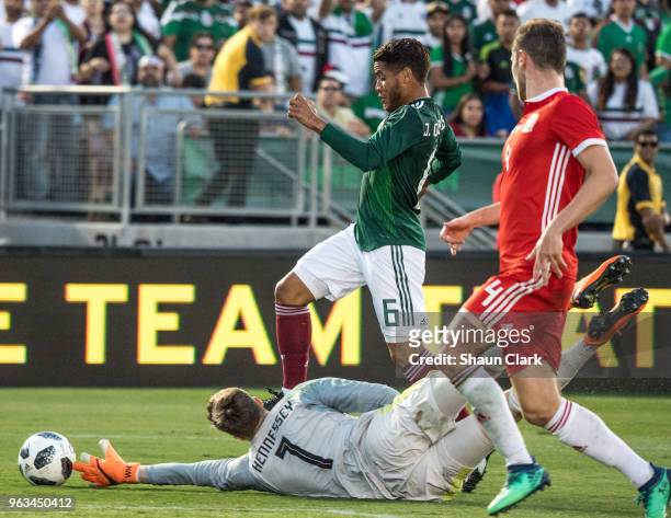 Wayne Hennessey of Wales knocks the ball away from Jonathan Dos Santos of Mexico during the international friendly match between Mexico and Wales at...
